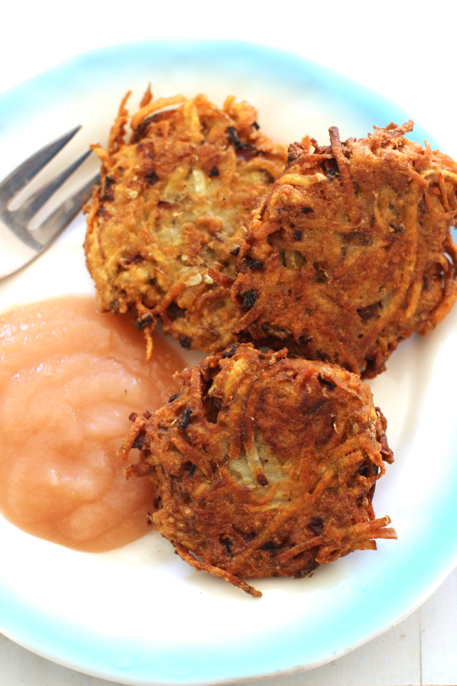 Classic latkes. This recipe by Alison Ladman is spiked with chipotle sour cream. (AP Photo/Matthew Mead)