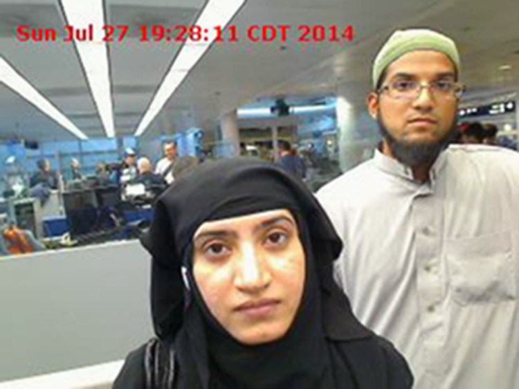 This photo provided by U.S. Customs and Border Protection shows Tashfeen Malik, left, and Syed Farook as they passed through O’Hare International Airport in Chicago on July 27, 2014.
