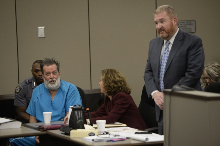 Attorney Rose Roy, center, tries to quiet Robert Lewis Dear during his outburst in court Wednesday while attorney Daniel King argues on Dear’s behalf. Dear, accused of killing three people and wounding nine others at a Colorado Springs Planned Parenthood clinic on Nov. 27, was charged with first-degree murder. He repeatedly interrupted King during Wednesday’s hearing, and objected to King’s attempts to limit publicity in the case.