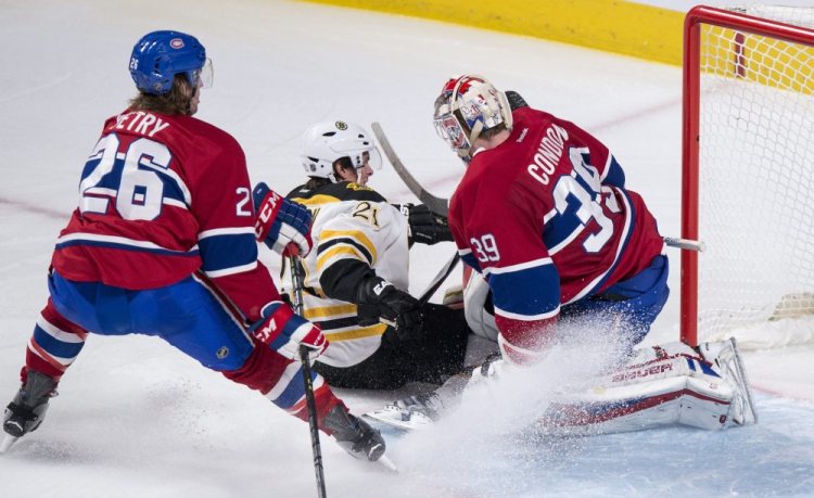 The Bruins’ Loui Eriksson slides away from Montreal defenseman Jeff Petry after scoring a short-handed goal past goalie Mike Condon in the third period Wednesday night in Montreal. The goal tied the game, and the Bruins went on to defeat the Canadiens, 3-1.