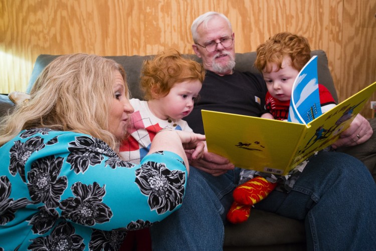 Cynthia and Michael Fielders read a Curious George book to their grandchildren Mercedes, 2 and Bentlee, 3. The couple were already raising the grandchildren when her son overdosed, Cynthia Fielders said, because her son’s addiction meant he couldn’t care for them. The children’s mother is in prison for trafficking drugs, she said.