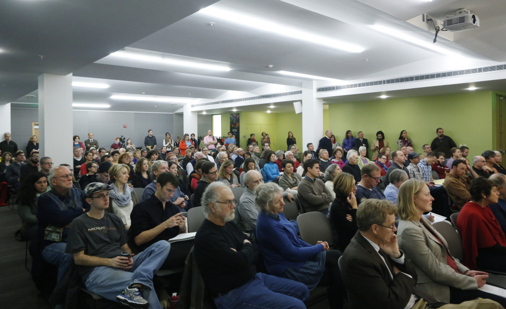 More than 100 people attend a forum to discuss city housing issues at the Portland Public library on Thursday.
