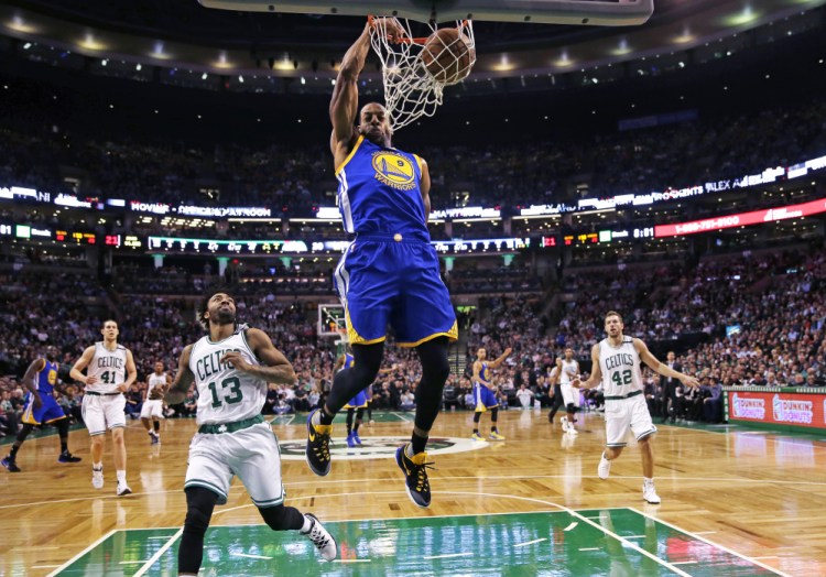 Warriors forward Andre Iguodala slams a dunk over Celtics guard James Young in the first quarter of what turned out to be a very long game – and a Warriors win.