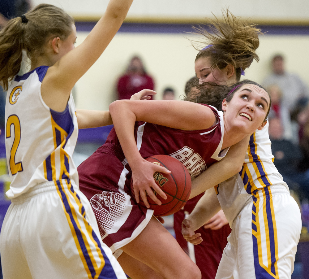 Cheverus defenders Brooke Dawson, left, and Kaylin Malmquist surround Bangor’s Katie Butler. Dawson and Malmquist each scored eight points for the Stags, who rallied in the second half to prevent Bangor from earning its first win of the young season.