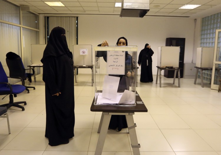 Saudi women vote at a polling center during municipal elections in Riyadh, Saudi Arabia, Saturday.
