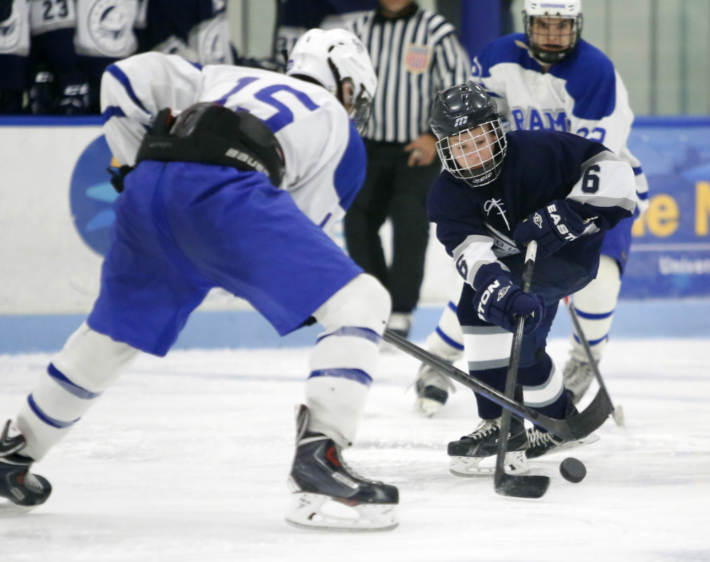 Joe Truesdale, right, of Yarmouth tries to get past Miles Eaton of Kennebunk during Saturday’s game in Biddeford.