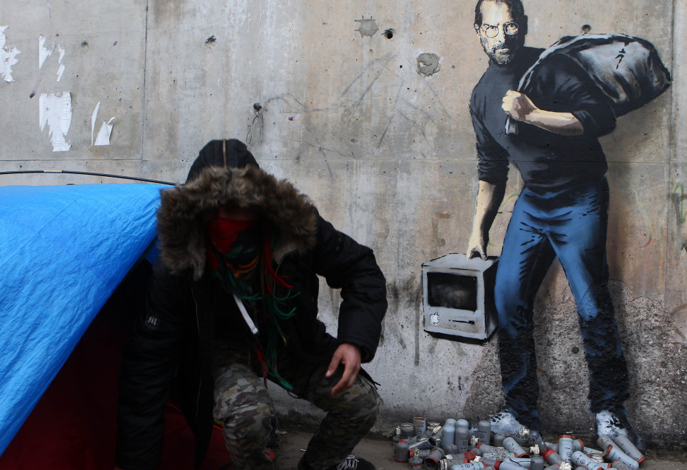 Artist Banksy’s mural at a refugee camp pictures Steve Jobs, whose biological father was Syrian, as a migrant.