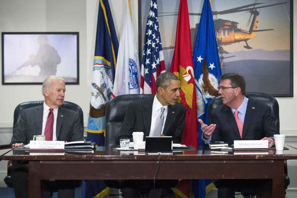 President Barack Obama talks with Vice President Joe Biden and  Defense Secretary Ash Carter during a meeting with the National Security Council about the fight against the Islamic State group Monday at the Pentagon.