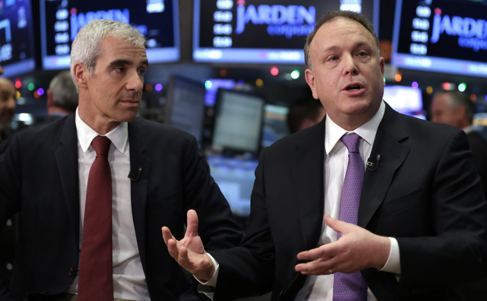 Jarden Corp. founder and CEO Martin Franklin, left, and Michael Polk, Newell Rubbermaid president and CEO, are interviewed at the New York Stock Exchange on Monday.