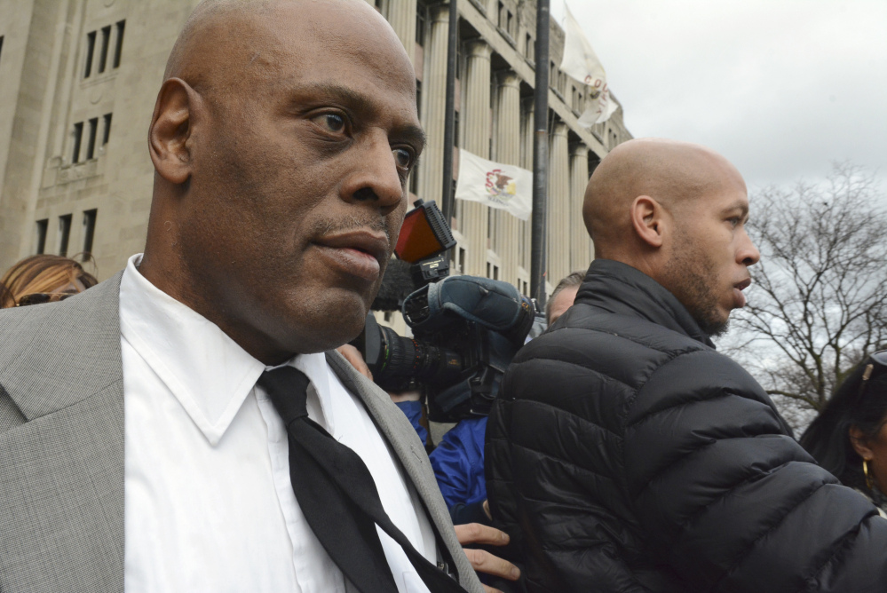 Chicago Police Cmdr. Glenn Evans, left, leaves the Cook County courthouse Monday after being acquitted of shoving his gun down a suspect’s throat in 2013.