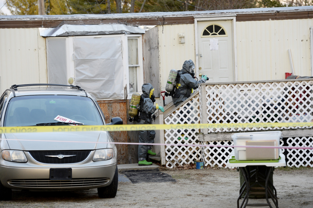 Members of the Maine Drug Enforcement Agency approach the home at 125 Old Thompson Road in Buxton on Tuesday to investigate a possible methamphetamine lab.
