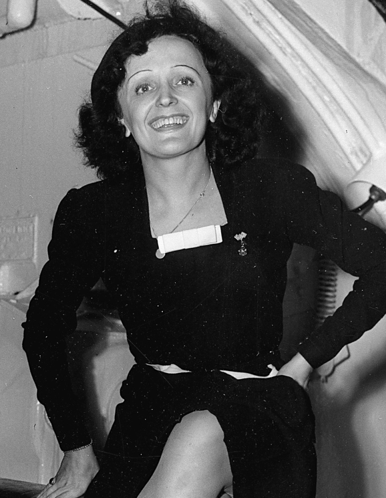 Parisian singer Edith Piaf poses aboard the Queen Elizabeth as she arrives in New York City on Oct. 16, 1947. 