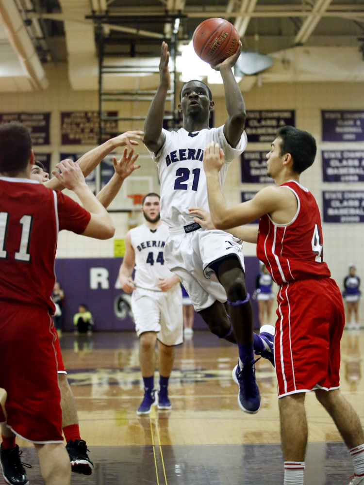 Deering’s Ben Williams drives to the basket past Sanford’s Tye Laviolette during the Rams’ 67-38 win Tuesday in Sanford. Williams scored 27 points.