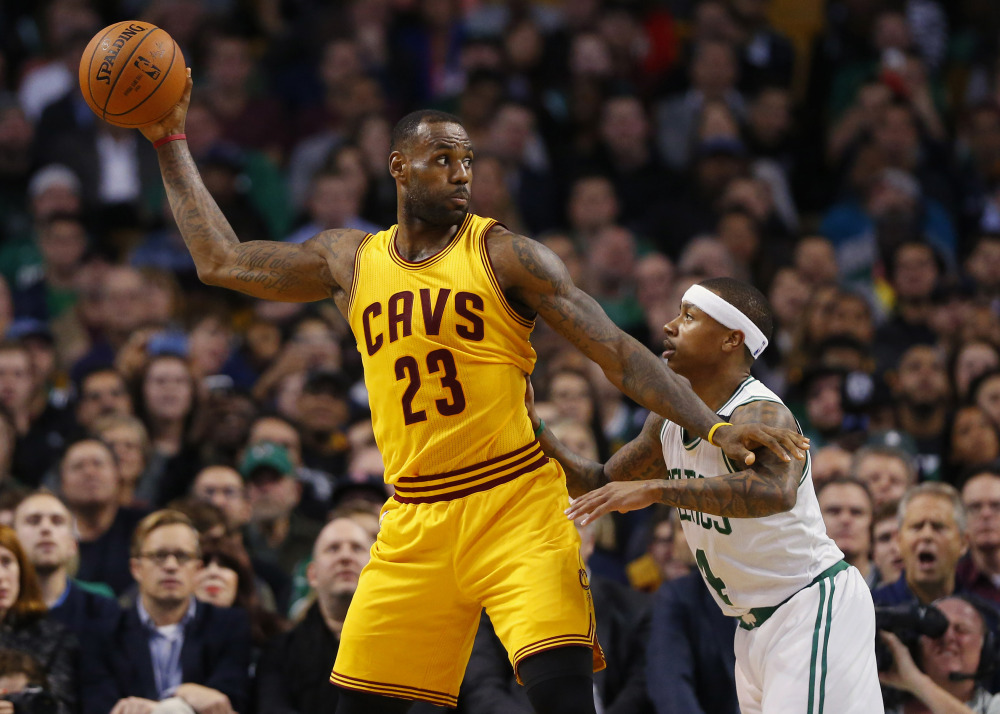 LeBron James holds the ball away from Celtics guard Isaiah Thomas in the second quarter of Tuesday night’s game in Boston. Celeveland came away with an 89-77 win.