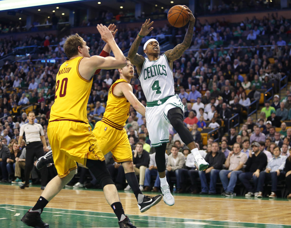 The Celtics’ Isaiah Thomas drives past the Cavaliers’ Timofey Mozgov (20) and Matthew Dellavedova in the first quarter.