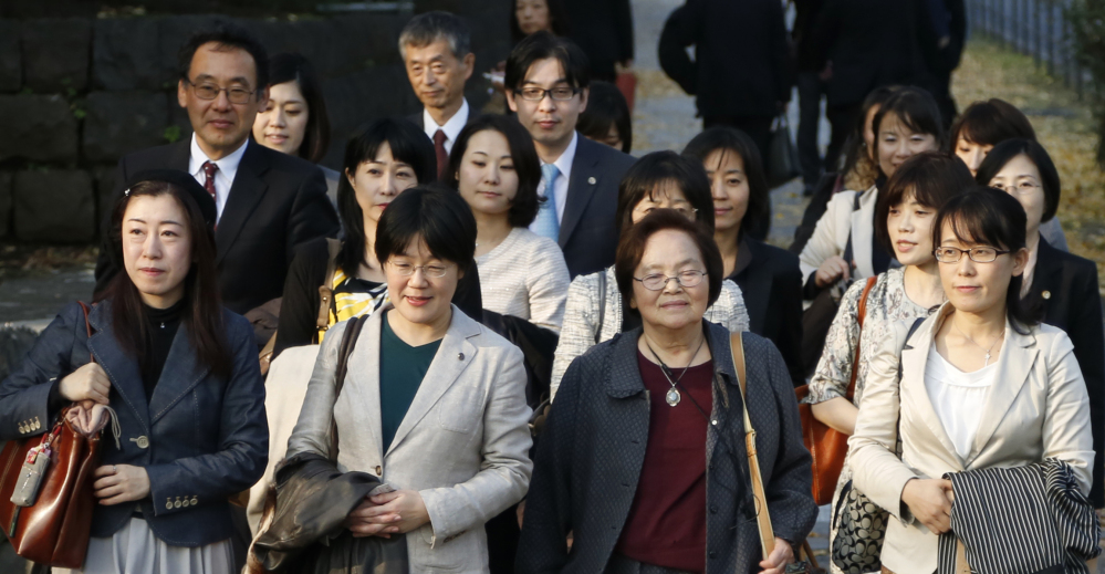 Plaintiffs and their supporters walk to Japan’s Supreme Court in Tokyo on Wednesday.