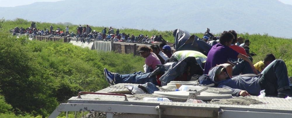 People trying to reach the U.S. ride atop a freight train in 2014. Figures for 2015 show unaccompanied minors are crossing  the U. S. Southwest border in larger numbers.