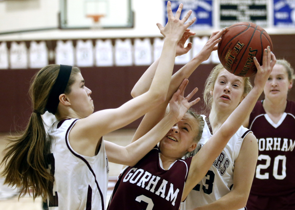 Kaylea Lundin, whose late 3-pointer put away the victory for Gorham, is in the middle of a rebound tussle Wednesday night with Isabel Porter, left, and Anna DeWolfe of Greely. Gorham reached 5-0 by holding on for a 57-49 victory.