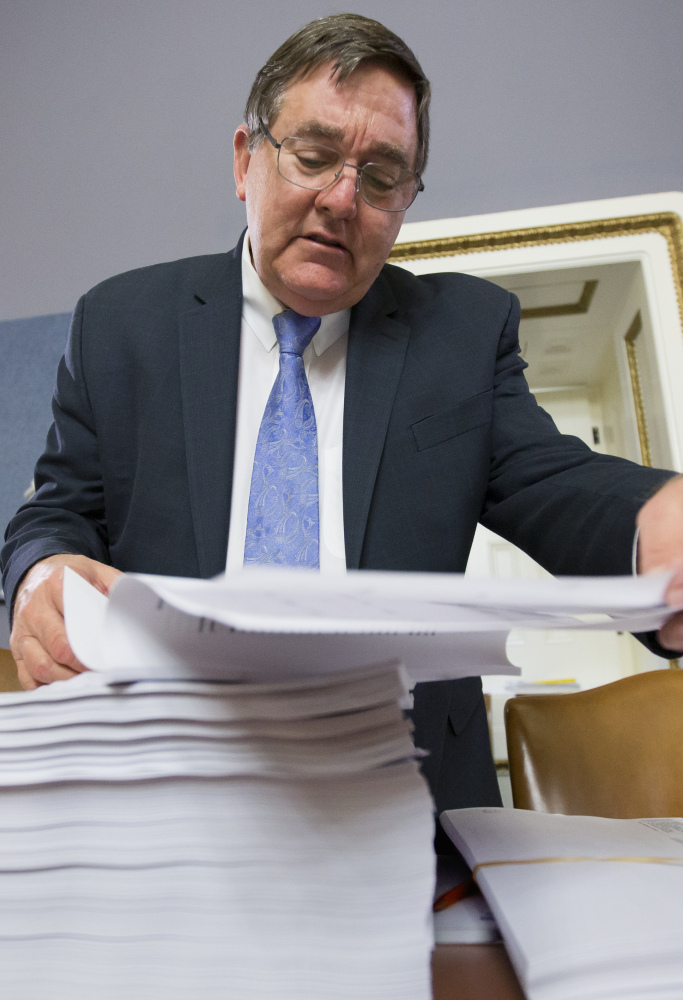 Rep. Michael C. Burgess, R-Texas, with a printout of the $1.1 trillion spending bill to fund the government for 2016.