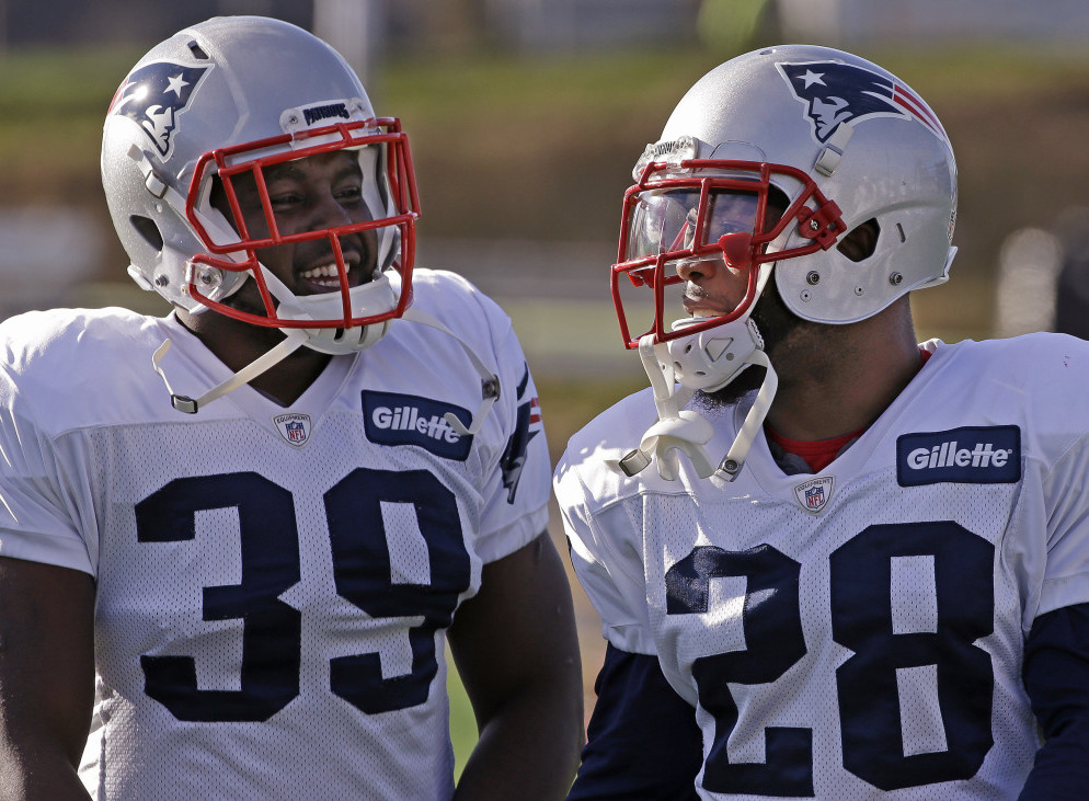New England’s newly acquired running back, Montee Ball, left, talks with new and former teammate James White at practice this week. Ball and White were teammates and roommates at the University of Wisconsin.