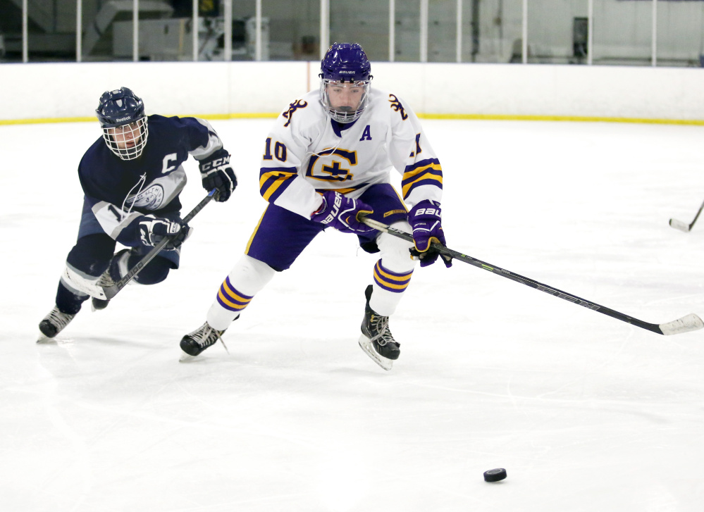 Patrick Grant, left, of Yarmouth and Garett Dion of Cheverus battle for the puck. Grant finished with a goal and two assists.