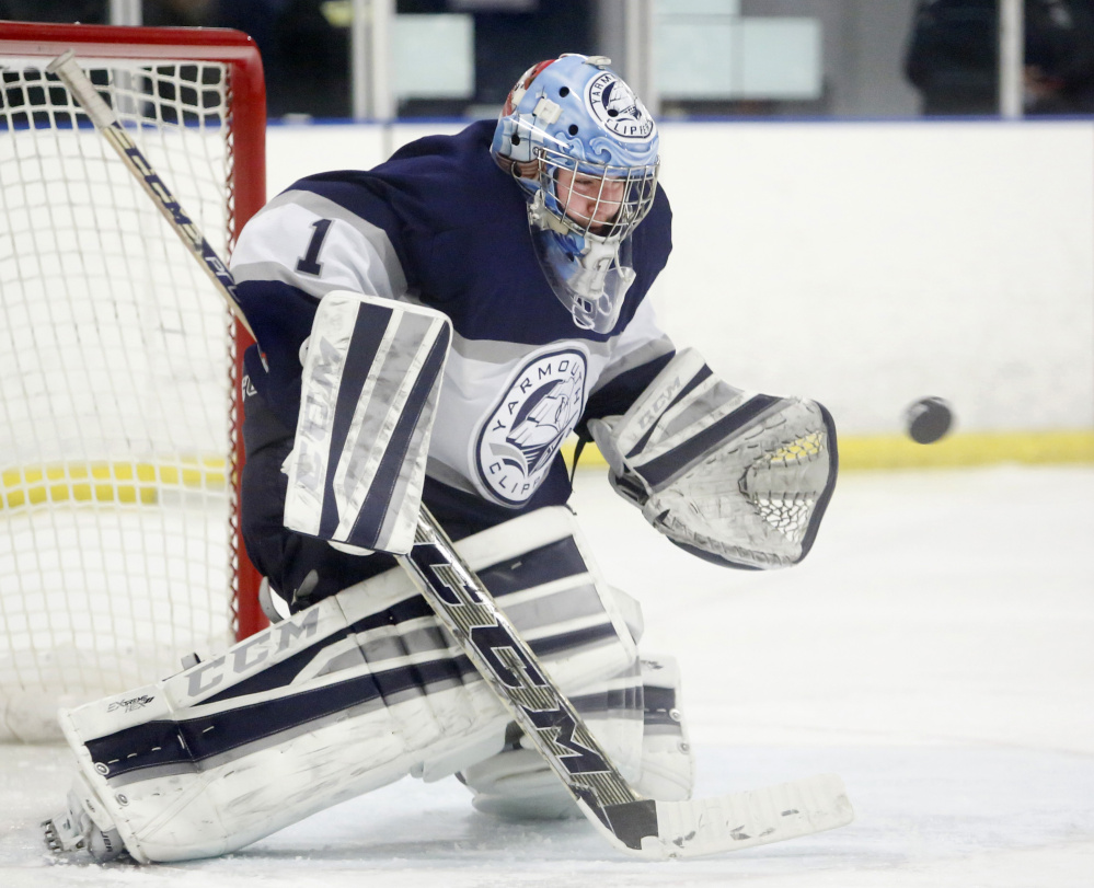Yarmouth goalie Dan Latham makes a save during the second period Thursday against Cheverus. Yarmouth improved to 4-0 with a 4-3 victory.