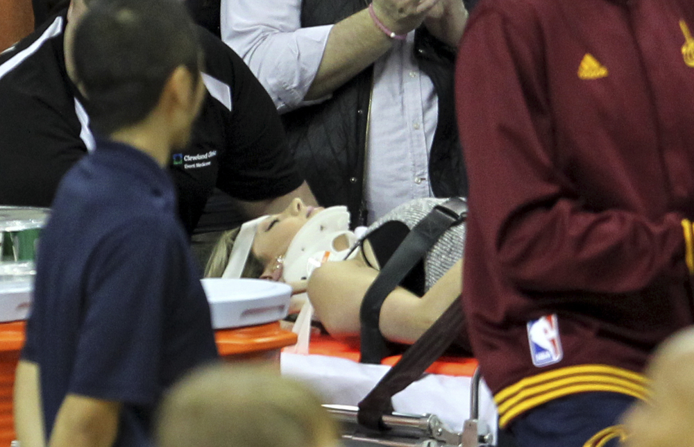 Ellie Day, wife of PGA star Jason Day, is carried off the floor in a stretcher after the Cleveland Cavaliers’ LeBron James plowed into her out of bounds in the second half of a game against the Oklahoma City Thunder on Thursday night in Cleveland.