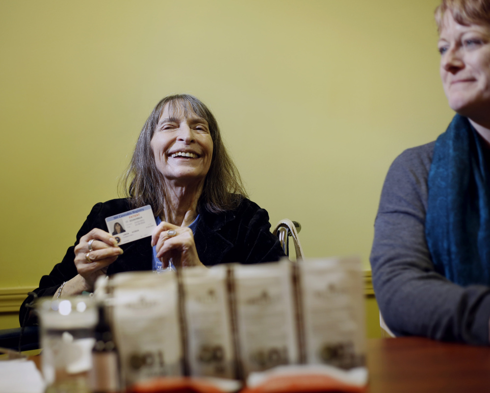 Linda Horan, a New Hampshire resident with end-stage lung cancer, talks to the media after purchasing medical marijuana products at Wellness Connection in Portland on Friday.