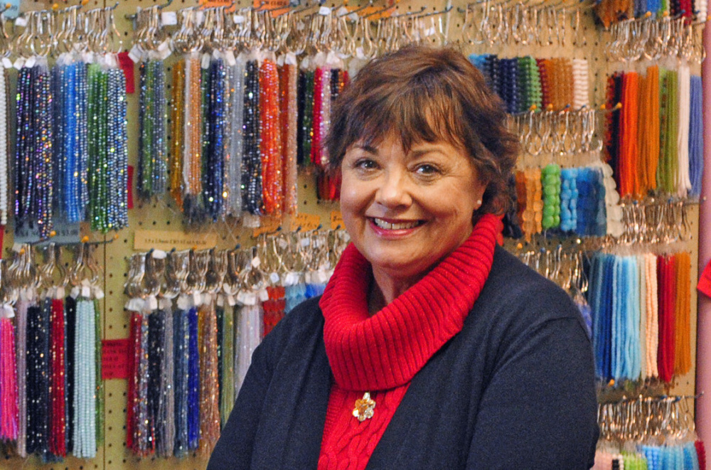 Linda LaCroix, owner of Beads on the Kennebec in Augusta, sends customers to other Water Street businesses to support them.
