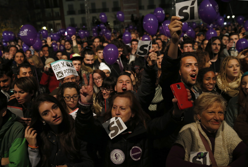 Supporters of the Podemos party wait for official results in Madrid on Sunday.