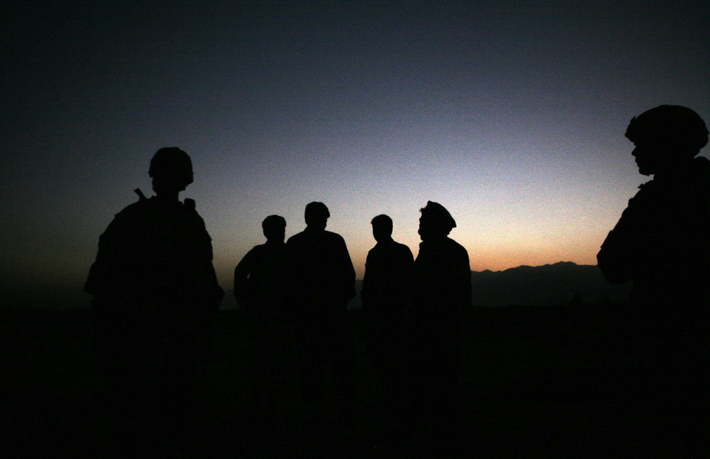 U.S. Army soldiers stand with Afghan policemen before a joint patrol of Qalanderkhail, outside of Bagram Airfield in Afghanistan in this file photo.