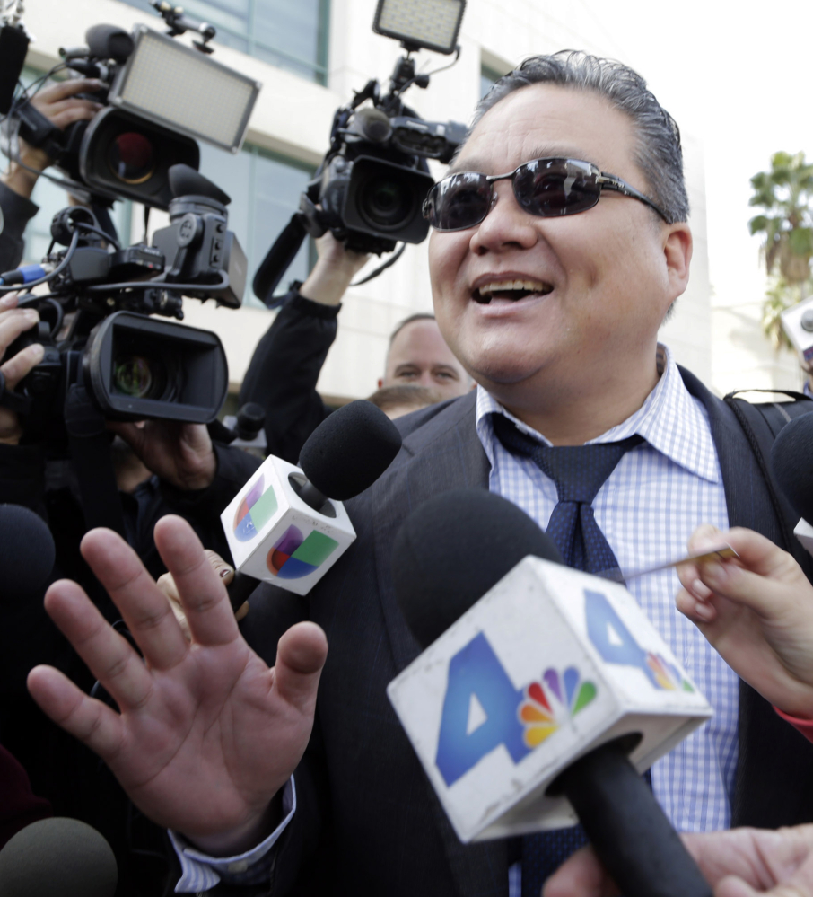 Young Kim, defense attorney for Enrique Marquez, addresses the media Monday in Riverside, Calif.