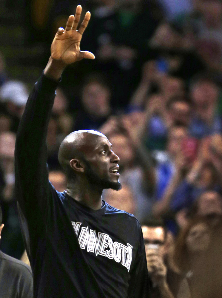 Former Celtics star Kevin Garnett, now playing for the Minnesota Timberwolves, acknowledges the Boston crowd during a timeout. Garnett was cheered throughout the game on his return to Boston.
The Associated Press