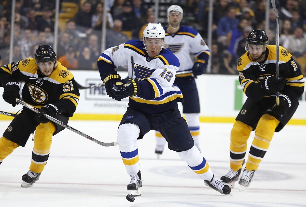 The Blues’ Jori Lehtera chases the puck ahead of Bruins Ryan Spooner (51) and Jimmy Hayes during the first period of St. Louis’ 2-0 win in Boston.