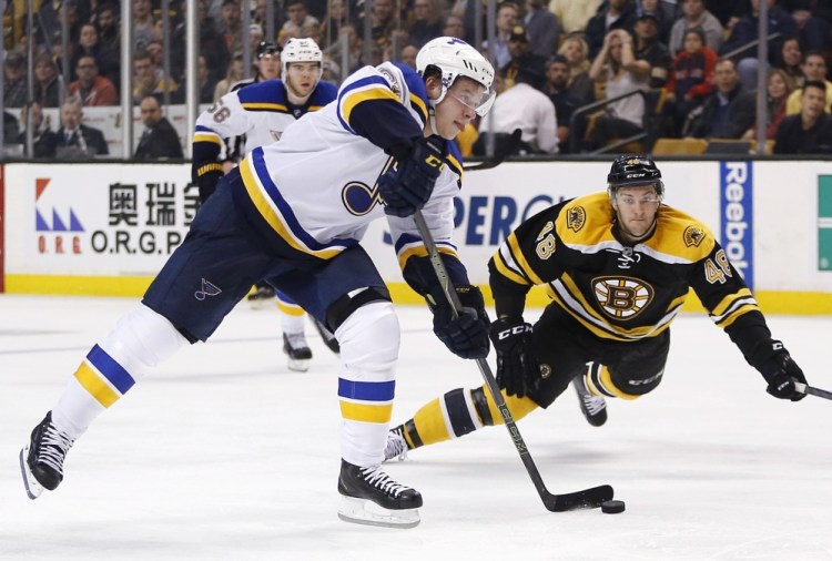 The Blues’ Vladimir Tarasenko sets up his scoring shot in the third period as the Bruins’ Colin Miller defends. The goal broke a scoreless tie and the Blues went on to win, 2-0.