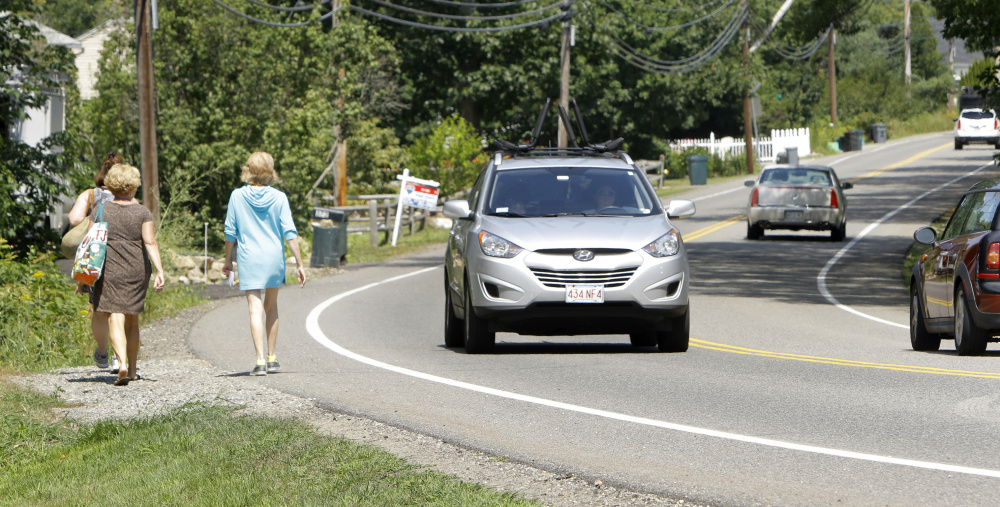 Women walk along Ridge Road in York near the site where police say Carolyn Lee, 21, of York, fatally struck a pedestrian, Emily Zarnoch, 23, of Massachusetts in August. Lee has been charged with manslaughter in the case.