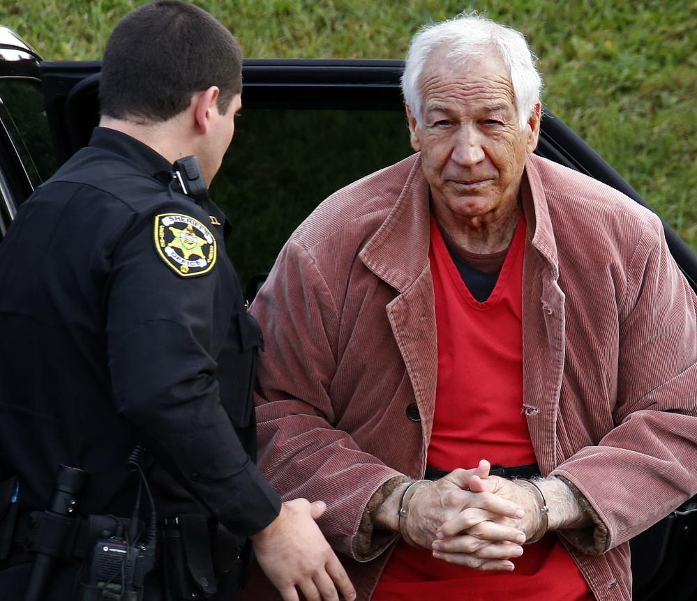 Former Penn State defensive coordinator Jerry Sandusky arrives at the Centre County Courthouse for an appeal hearing in Bellefonte, Pa., in October. The university has paid out nearly $93 million in claims in the sexual abuse case involving 10 boys.