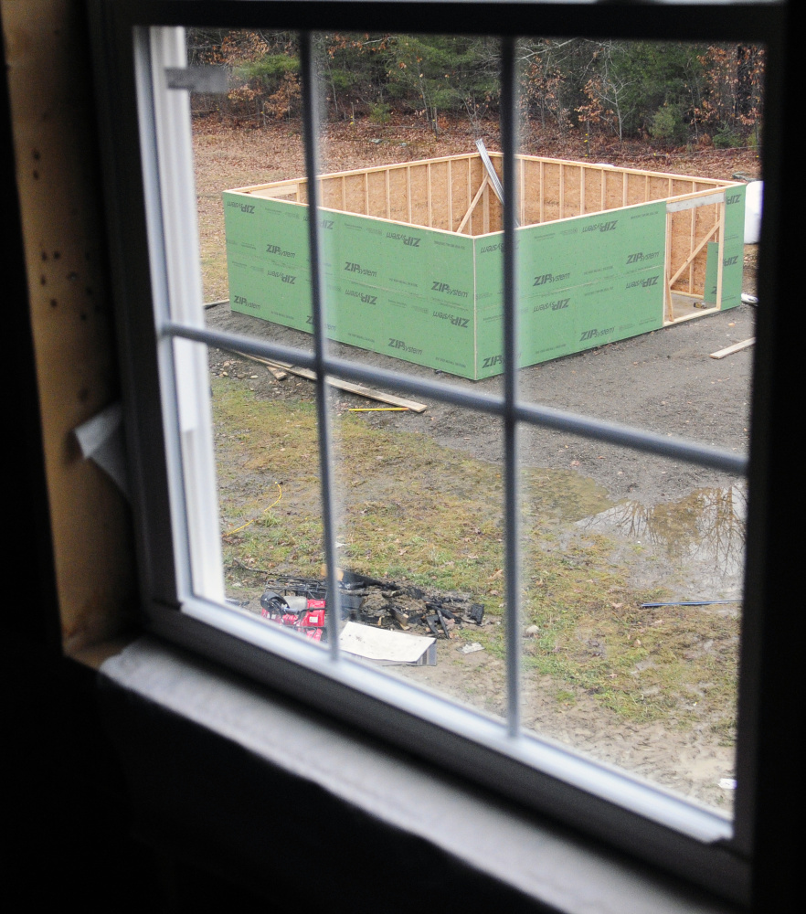 A second story bedroom window frames the new barn at the Peasley’s family home on Dec. 18 in Somerville.