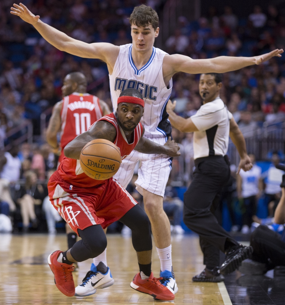 Houston Rockets guard Ty Lawson dribbles the ball as Magic guard Mario Hezonja defends during the second half of their game in Orlando, Fla., on Wednesday night. Orlando came away with a 104-101 win.