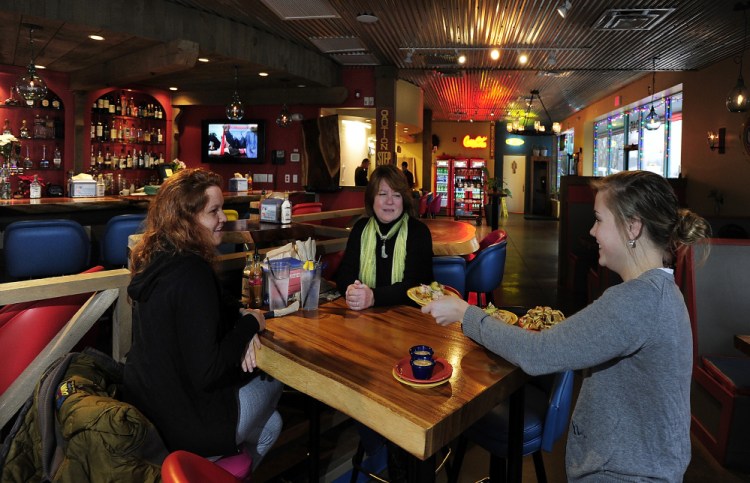 Server Lea Brown serves fish tacos, papas fritas and chipotle mayo to Kayla Porcelli, left, and Carrie Porcelli.