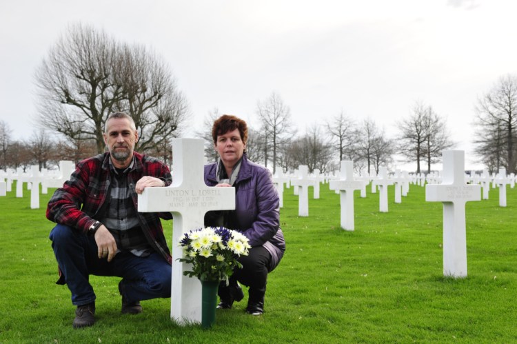 Jos and Monique Krick place flowers at the grave of Pfc. Linton Lowell of Portland, who was killed in action while serving with the U.S. Army in World War II and was buried in the Netherlands American Cemetery in Margraten.