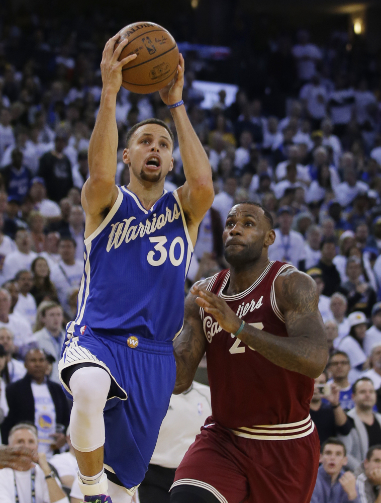 Stephen Curry of the Golden State Warriors drives past LeBron James of the Cleveland Cavaliers during the second half of the Warriors’ 89-83 victory Friday.