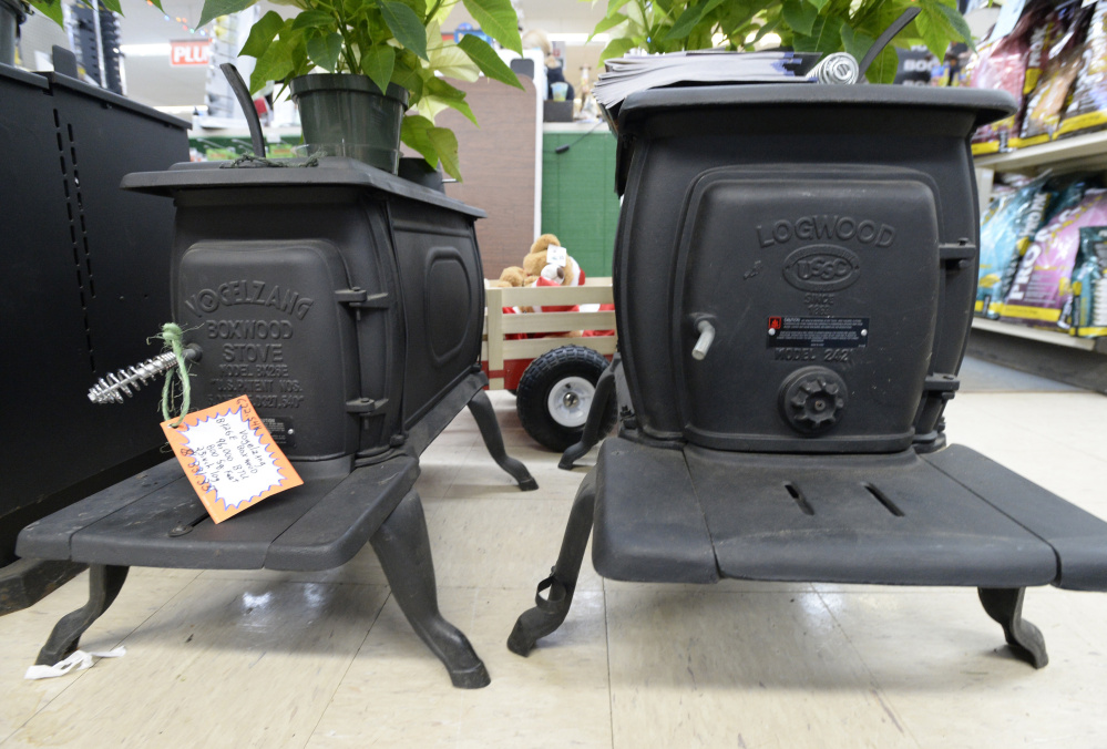 As of Jan. 1, stoves like these “EPA-exempt” models from Vogelzang, left, and Logwood, on display at Paris Farmers Union in Jay, will no longer be sold by U.S. retailers. New rules don’t apply to homeowners, however, who can resell units that are not in compliance with emission standards.