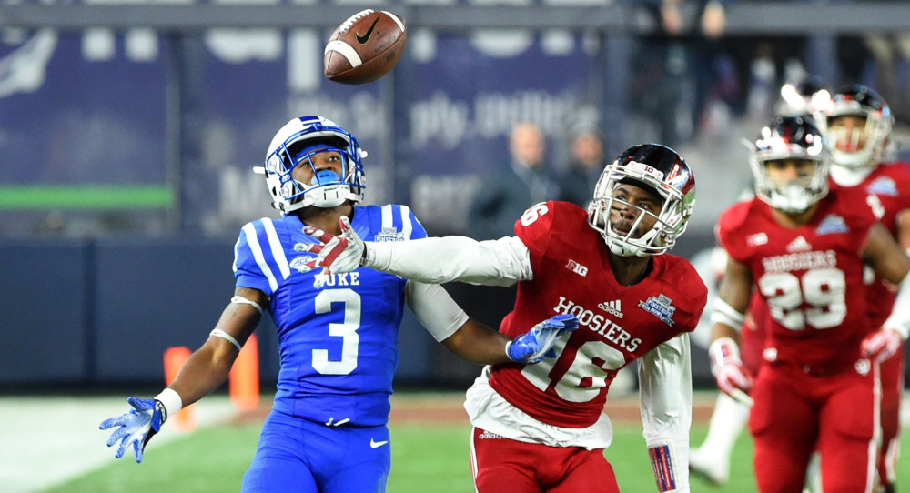 Rashard Fant of Indiana, center, breaks up a pass intended for T.J. Rahming of Duke during the second quarter of Duke’s 44-41 overtime victory Saturday in the Pinstripe Bowl at Yankee Stadium.