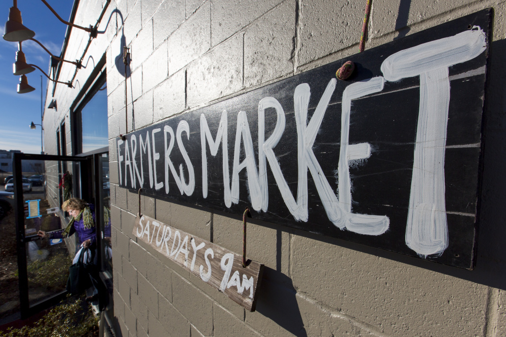 A customer exits the Portland Winter Farmers Market at its new location, 84 Cove St.