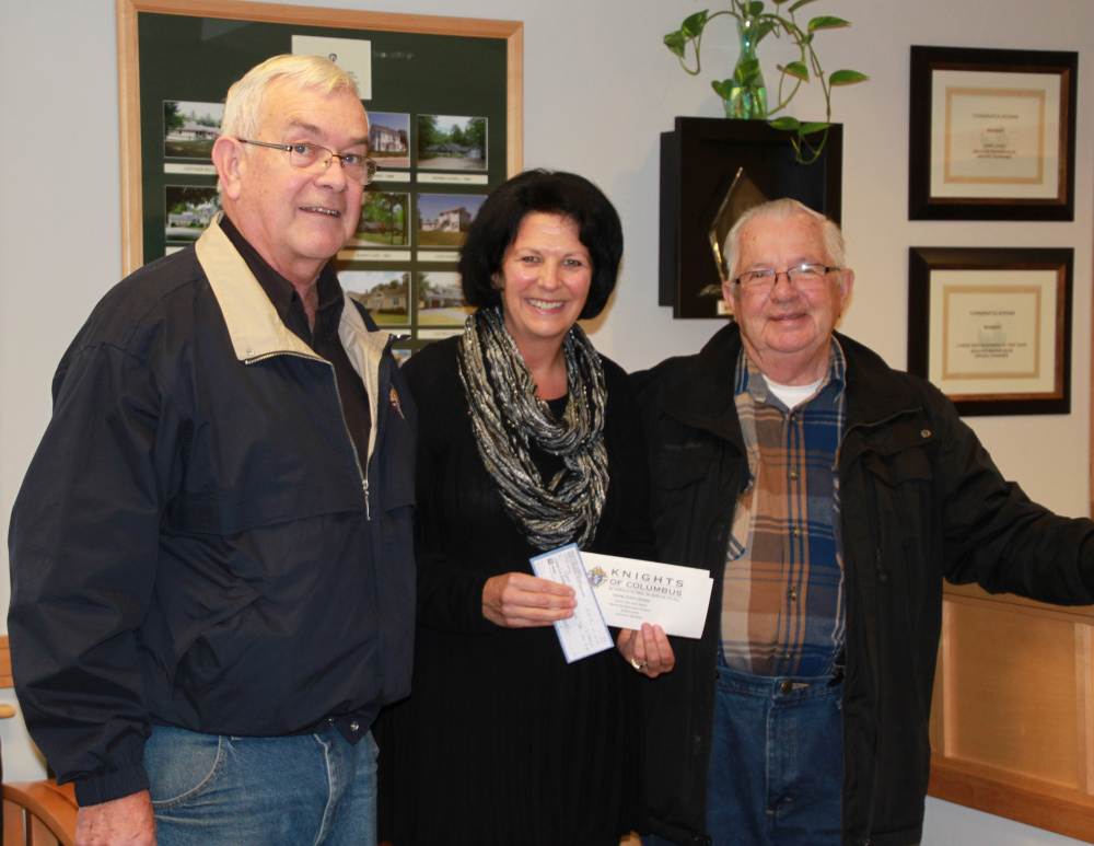 Gervaise Flynn, center, assistant executive director of Waban at Sanford, receives a donation of $1,784.60 from Knights of Columbus St. Thomas Council member Frank Pease and Knights of Columbus Springvale Council member George Watson. The money was raised by the K of C’s Tootsie Roll Drive and was pledged to kick off the 45th Annual Waban Telethon, set for March 19. In 2016, Waban will celebrate its 50th year of providing services for children and adults with intellectual/developmental disabilities. Photo courtesy Selena Brock