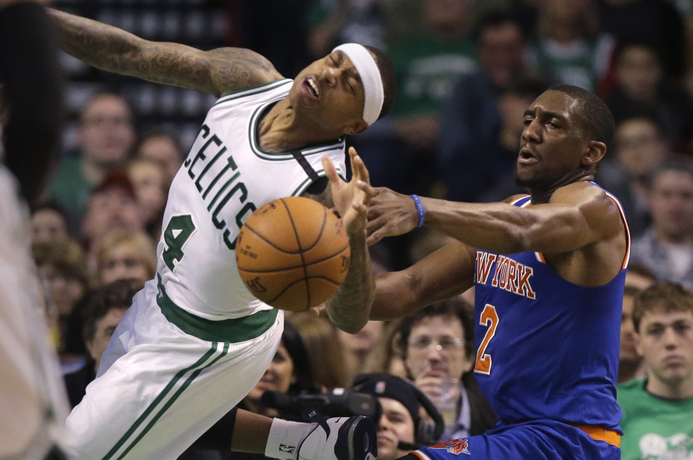 Celtics guard Isaiah Thomas, left, tries to drive to the basket past Knicks guard Langston Galloway, right, during the Celtics’ 100-91 win Sunday in Boston. Thomas scored 21 points.