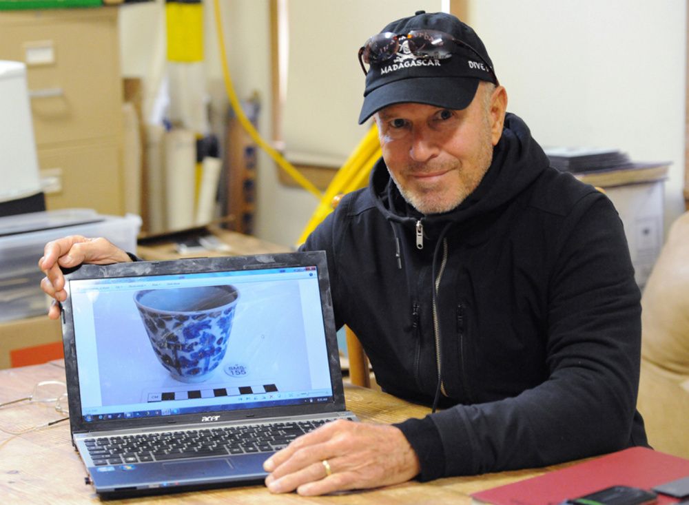 Underwater explorer Barry Clifford displays an image of a Kangxi period Chinese porcelain cup found in the Fiery Dragon shipwreck off Madagascar. Clifford plans to display artifacts recovered from the 300-year-old pirate ship Whydah in a museum in West Yarmouth, Mass.