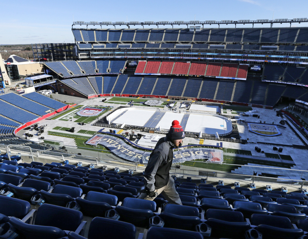 Workers are busy turning Gillette Stadium into an outdoor hockey arena for the Winter Classic between the Boston Bruins and the Montreal Canadiens on New Year’s Day.