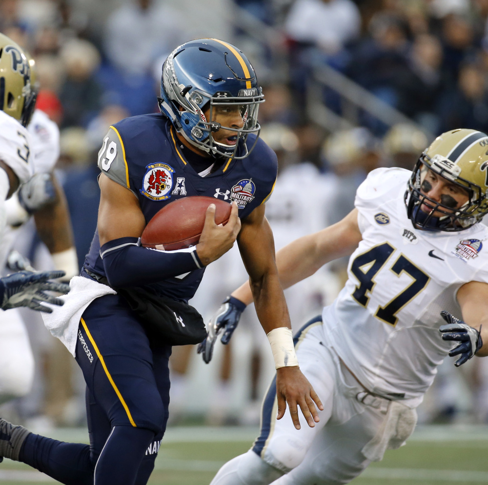 Navy quarterback Keenan Reynolds, center, ran for three touchdowns in Navy’s 44-28 win over Pittsburgh in the Military Bowl on Monday in Annapolis, Maryland.